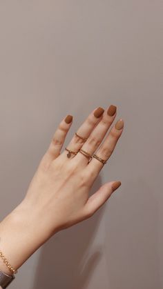 a woman's hand with three rings on it