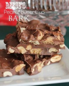 chocolate and nuts are stacked on top of each other in the middle of a white plate