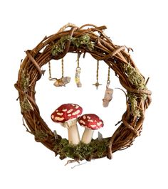 a wreath with mushrooms and moss hanging from it