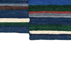 two blue and green striped rugs on white background