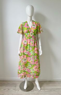 Vintage 1970s green and pink floral maxi dress. Sheer flutter sleeves, empire waist w/ ties at back, back zipper, front bodice and skirt is lined. Young Innocent by Arpeja, size 7, fits like a small. Feels like cotton poly gauze blend. Excellent vintage condition. Please message me with any questions.  Measurements bust 34 waist 26 hip 39 length 50.5 more vintage clothing  https://www.etsy.com/shop/prizesforarla instagram: prizesforarla international buyers: Please note that your order may be su 1970s Style Green Summer Dresses, 1970s Green Floral Print Dress, 1970s Style Green Floral Print Dress, Retro V-neck Maxi Dress For Spring, Retro Spring Maxi Dress For Daywear, Vintage V-neck Maxi Dress For Garden Party, Retro Green Floral Print Maxi Dress, Vintage Green Floral Print Dress, Green Retro Maxi Dress With Floral Print