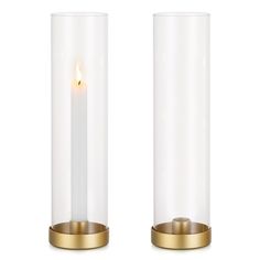 two glass vases with a lit candle inside one on each side and another in the middle