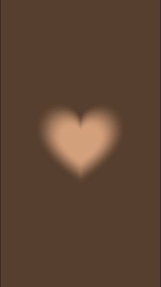 the shadow of a heart on a brown background