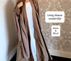 The perfect inner slip with long sleeves to style with any of our abayas. Each slip includes a belt too.  Material - soft touch Nidha (polyester)    Long sleeve - Black and half white. We also have a seperate listing for short sleeves.  https://www.etsy.com/listing/1352903192/abaya-slipunderslip-abaya-innerslip Please refer to the size guide in the images section.  No refunds/exchanges on this item. Elegant Long Beige Abaya, Modest Long White Thobe, Elegant Beige Long Thobe, Elegant Long Beige Thobe, Formal Long Solid Abaya, Elegant Fitted Long Abaya, Elegant Long Fitted Abaya, Elegant White Long Sleeve Abaya, Elegant Long White Abaya