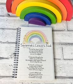 there is a spiral notebook with a rainbow on it and the words savannah's leaves book