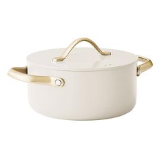 a white casserole with gold handles