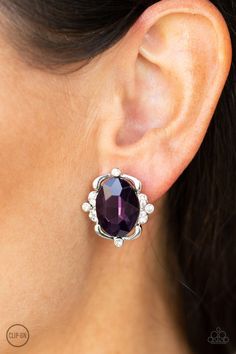 Sporadically dotted in sections of glassy white rhinestones, shimmery ribbons of silver gently fold around a dazzling purple emerald-style gem center for a regal look. Earring attaches to a standard clip-on fitting. Sold as one pair of clip-on earrings. P5CO-PRXX-022XX Color Uva, Paparazzi Accessories Jewelry, Emerald Style, Purple Gems, Purple Earrings, Oval Earring, Paparazzi Accessories, White Rhinestone, Affordable Jewelry