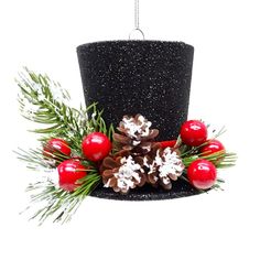 a black top hat with pine cones and berries hanging from it's centerpiece