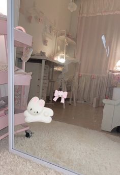 there is a mirror in the room that has a hello kitty decoration on it and pink furniture