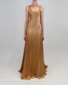 The Deepika gown features a scoop neckline and an elegant asymmetrical waistline that cascades into a flowy skirt with a smooth drape. Flowy Lace Dress, Charmeuse Gown, Earth Tone Dress, Open Back Gown, Midi Gowns, Chiffon Gown, Fancy Pants, Bridesmaid Gown, Flowy Skirt