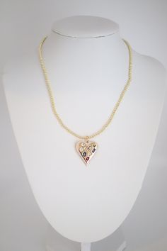 A Gold Beaded Necklace with Heart Pendant combines timeless elegance with a touch of romance, featuring a string of gold beads leading to a heart-shaped pendant. This accessory adds a sweet and sophisticated element to any outfit, making it a versatile and sentimental piece of jewelry. Heart Pendant Necklace With Charm For Party, Elegant Heart Beads Necklace For Party, Elegant Party Heart Beads Necklace, Party Necklace With Heart Pendant And Beads, Party Necklaces With Heart Beads And Pendant, Heart Charm Necklace For Party, Party Necklace With Heart Bead Pendant, Heart Pendant Necklace With Heart Beads For Party, Party Heart Pendant Beaded Necklace