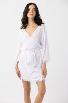 The Sunset Robe transforms relaxing moments into pure bliss. This rayon robe was designed with delicate crochet lace trim lines the waist and sleeves, adding elegance and ornate detail. Embroidered by hand, the intricate cutwork detail exudes craft and old world love. Details: 100% Rayon Hand Wash & Lay flat to dry Features: Unlined, Embroidery throughout sleeves and hemline V-neck Lace Trim Robe For Daywear, Feminine Delicate Lace Sleepwear For Beach, White V-neck Cover-up For Loungewear, White V-neck Loungewear Cover-up, Long Sleeve Lace Trim Beach Cover-up, Summer Lace With Lace Trim For Beach, Elegant Lace Trim Sleepwear For Vacation, Delicate Lace Sleepwear For Beach, Lace Cover-up With Lace Trim For Vacation