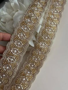 Embellish your designs with this stunning embellished pearl trim  that combine beautiful Glass bead accents. The Beautiful Hand Made Fringe Is Gothic and perfect for costume designers and add a touch of grandeur and opulence to your attire.  We are constantly adding new items and you will be sure to find our complete inventory with 1000's of designs at www.lacetrimssindia.com PLEASE NOTE : ALL ORDERS ARE SHIPPED FROM THE INDIA RETURN POLICY *All broken case can be re-sent or refund if the condition is proven by photo . *Exchange item or refund case can be accepted within 5 days after receiving the item. Return shipping charge is pay by buyer if it is not our fault. SHIPPING *All postage provide tracking number *Delivery Time : 10 - 20 business days normally but may be sometimes about 1 mon Gold Lace Fabric With Pearl Embroidery, Gold Embellished Embroidered Fabric For Ceremony, Elegant Embellished Embroidered Fabric For Celebration, Festive Gold Embroidered Fabric With Pearl Details, Elegant Pearl Embroidered Fabric For Celebration, Festive Gold Fabric With Pearl Embroidery, Elegant Gold Embroidered Fabric With Pearl Details, Gold Beaded Lace Embroidered Fabric, Gold Beaded Embroidered Fabric For Festive Occasion