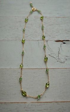 This adorable handmade baby necklace is made from 14k gold filled chain and components. A fine metal composed of solid gold infused on sterling silver, this is NOT plated and will last a life time. Such sweet beautiful mix of peridot gemstones and petite peridot color Swarovski crystals. Special August baby necklace or a gift for a boy or girl for any occasion. For your little ones safety I carefully wire wrap each stone and component. No lose parts and no jump rings used in my designs. I can ma 14k Gold Filled Birthstone Necklace For May, Delicate Green Birthstone Necklace, Green 14k Gold Filled Jewelry With Delicate Chain, Delicate Green 14k Gold-filled Jewelry, Dainty 14k Gold Filled Necklace For May Birthstone, Dainty 14k Gold Filled Necklace With May Birthstone, Dainty Green Birthstone Jewelry, 14k Gold Green Birthstone Necklace, Handmade 14k Gold Green Necklace