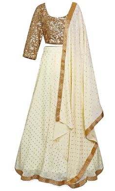 The lehenga skirt is crème in color, and the long-sleeve blouse is completely covered in gold sequins. Festive Beige Georgette Lehenga, Beige Georgette Lehenga With Zari Work, Unstitched Cream Lehenga, Beige Party Sets With Traditional Drape, Festive Embellished Beige Sharara, Festive Beige Embellished Sharara, Cream Lehenga With Traditional Drape For Parties, Semi-stitched Cream Lehenga For Party, Elegant Cream Choli For Party