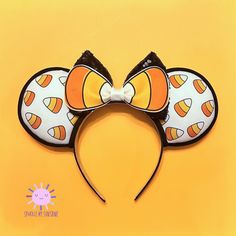 Whether you love candy corn for Halloween or fall in general, you're going to love these Candy Corn Halloween Disney Ears. Fun and unique shades of white, yellow and orange candy corns cover the ears while a fun double bow of black glitter sequin and candy corn faux leather bow centers the mouse ears headband. Perfect for an autumn harvest or Disneyland Halloween party.Ears: Park size 4" filled with premium poly-filling for a fluffy look at feelBow: large 5"Headband Type: 1" Satin (fits adults, Disney Ears Halloween, Halloween Disney Ears, Halloween Mouse Ears, Candy Corn Headband, Fitted Halloween Headband, Disneyland Halloween Party, Cute Adjustable Halloween Headband, Candy Corn Halloween, Disney Headbands