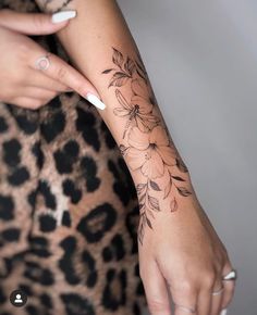 a woman with a flower tattoo on her arm