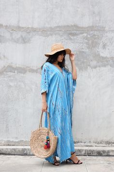 This beautiful Tie-Dye Kaftan makes for easy elegance and comfort, at home, at the beach, or on a casual day out.  Flowy fit | One Size  Length: 54 inches | 137 cm Width: 31.5 inches | 80 cm Side Slits: 26 inches | 66 cm Made in Thailand with Love 100% Rayon Washing Instructions:  Hand Wash or Delicate Cycle, Cold Water, Wash Separately, Lay Flat or Hang to Dry *Actual colors and patterns may slightly vary due to the handmade origin of the item and your screen color resolution preferences. Blue Boho Dress For Beach Cover-up, Light Blue V-neck Maxi Dress For Beach, Bohemian V-neck Maxi Dress For Resort, Summer Turquoise Maxi Dress For The Beach, Blue Tunic Beach Dress For Vacation, Blue Boho Beach Dress As Beach Cover-up, Blue Boho Beach Dress Cover-up, Turquoise Beachwear Maxi Dress For Beach, Blue Boho Beach Dress For Cover-up