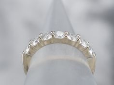 a diamond ring sitting on top of a metal pole