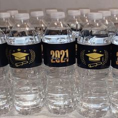 several bottled water bottles are lined up on a table