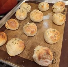 freshly baked rolls on a baking sheet ready to go into the oven in the oven