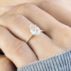 a woman's hand with a diamond ring on it