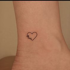 a small heart tattoo on the ankle