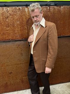 Classic 1970s mens 2 button Sportcoat in warm Carmel brown. Mod geometric off white and brown lining. High quality double knit in subtle diamond pattern. Wide rounded lapels, top stitching , side vents. Original metal enameled buttons at center front and sleeve cuffs. Partial lining on front and back panels. Overall this sport coat is in remarkably good condition, only signs of wear are on sleeve and side hems. Measurements are taken with garment flat in inches Chest 46 Shoulder seam to Shoulder Carmel Brown, Mens Sport Coat, Top Stitching, Jacket Buttons, Double Knitting, Sport Coat, 1970s, Overalls, Off White