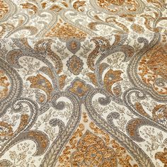 an orange and white paisley print fabric