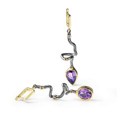 These asymmetric earrings from German Kabirski's Bacchus Bunch Collection feature one pear-cut Amethyst and one oval-cut Amethyst, plated with Black Rhodium and 18K Gold. Inspired by Bacchus, the Roman god of wine, hedonism, and artistic expression, these earrings embody the spirit of indulgence and clarity. Amethyst, often associated with Bacchus, is believed to enhance mental clarity and provide a sense of calm. These unique earrings are perfect for those who celebrate life's pleasures and seek a clear mind. Metal: 925 Silver Stones: Amethyst Plating: Black Rhodium, 18K Gold  Please Note: Natural gemstones may appear different under various lighting conditions. For the most accurate representation, refer to the model photo. The natural raw gemstones in this design may display inclusions, August Birthstone Jewelry, July Birthstone Jewelry, Fine Art Jewelry, Clear Mind, Jewelry Ring Box, Men's Jewelry Rings, Pearl Jewellery Earrings, Black Rhodium, Amethyst Earrings