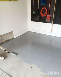 a man is laying concrete on the floor