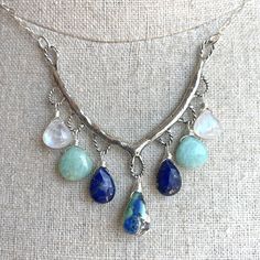 An heirloom piece. The artisan work on this solid sterling silver piece is just gorgeous. I have added a focal Arizona lapis turquoise, lapis lazuli, amazonite, and rainbow moonstone wired in sterling silver to sterling silver chain with a 4" extender with lapis on the end. This necklace can be adjusted from 16" to 20". There is a very limited quantity available, so if you love it, don't wait! The focal stone will be unique for each piece but the other stones used are fairly uniform. Your neckla Bohemian Sterling Silver Dangle Necklaces, Bohemian Sterling Silver Gemstone Necklaces, Bohemian Sterling Silver Gemstone Necklace, Bohemian Sterling Silver Wire Wrapped Jewelry, Bohemian Sterling Silver Jewelry For Healing, Bohemian Sterling Silver Crystal Necklace, Silver Dangle Necklaces With Natural Stones, Blue Labradorite Bohemian Jewelry, Bohemian Blue Labradorite Jewelry