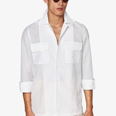 Elevate your off-duty look with this pure white Safari shirt, flaunting a prominent collar and seamless French placket. A single cuff and dual chest pockets add to the easy-going yet polished appeal. Casual White Shirt With Lapel Collar, Classic Summer Shirt With Fold Down Collar, White Shirt With Hidden Button Closure For Spring, Classic Summer Shirt With Concealed Placket, Classic Formal Tops With Pockets, White Shirt With Concealed Placket For Summer, Formal Shirt With Pockets And Lapel Collar, Formal Shirt With Pockets And Relaxed Fit, Formal Shirt With Spread Collar And Pockets