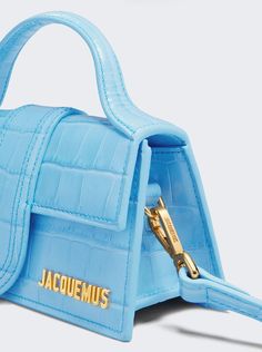 Small flap bag Structured crocodile-effect leather bag Padded top handle Magnetic flap tab closure Long removable strap Engraved lobster clasp Patch pocket on the back Topstitched details Gold metal logo and hardware Fully lined in cotton Dyed edges Luxury Blue Shoulder Bag With Magnetic Closure, Luxury Blue Shoulder Bag With Snap Closure, Luxury Blue Leather Baguette Bag, Luxury Light Blue Shoulder Bag With Gold-tone Hardware, Luxury Designer Blue Shoulder Bag, Luxury Modern Blue Flap Bag, Luxury Blue Flap Bag With Magnetic Closure, Blue Luxury Flap Bag, Luxury Blue Flap Bag