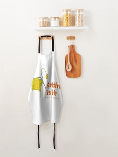 a kitchen towel hanging on the wall next to a cutting board and utensils