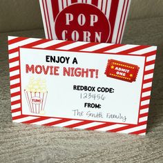 two red and white striped popcorn boxes with movie tickets on the front one is empty