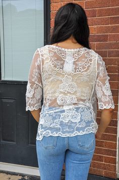 The Embroidered Lace Cardigan is a stunning and versatile piece that adds a touch of elegance to any ensemble. Made from a blend of 65% cotton and 35% acrylic, this cardigan offers a comfortable and breathable feel. The intricate embroidery and lace detailing elevate its aesthetic, giving it a sophisticated and feminine charm. With its 3/4 sleeves, it provides just the right amount of coverage for transitioning between seasons. The mesh fabric adds an airy and lightweight texture, making it perfect for layering over your favorite tops or dresses. Whether you're dressing up for a special occasion or adding a chic layer to your everyday look, the Embroidered Lace Cardigan is sure to make a statement. White Cotton Cardigan With Floral Embroidery, Summer Cotton Cardigan With Floral Embroidery, Fitted Cotton Cardigan With Floral Embroidery, White Embroidered Cotton Cardigan, White Embroidered V-neck Cardigan, Fitted Embroidered Cotton Cardigan, Fitted White Cardigan With Floral Embroidery, Spring Lace Tops With Intricate Embroidery, Fitted Embroidered Crew Neck Cardigan