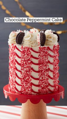 a red and white cake sitting on top of a wooden stand with the words bake a candy cane cake