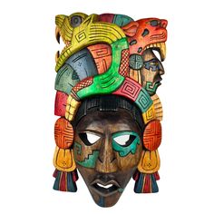 an african mask with colorful designs on it's face and headdress, isolated against a white background