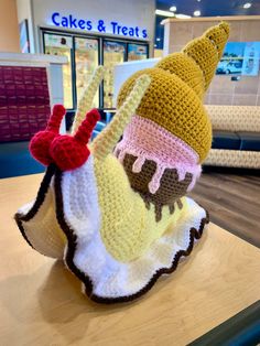 there is a crocheted ice cream cone on top of a table in the store