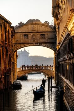 a gondola in the water under a bridge