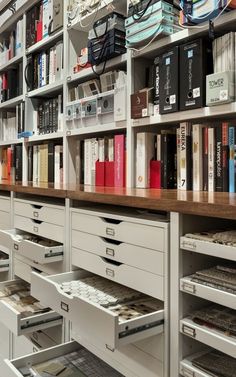 the shelves are full of books and files