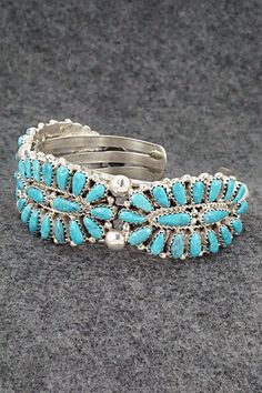 This turquoise and sterling silver bracelet was made by Navajo silversmith Jaz Wilson. The inside is signed J Wilson and S/S.Size: 5 3/4" (will fit up to a 6 1/2" wrist)Gap: 3/4"Width: 7/8"Free shipping on all orders! We ship with USPS and always include tracking. All orders ship within a day of payment.Returns are accepted up to 30 days after you receive your order. Just send us a message. Our shop offers cash back or store credit. The item must be returned in new condition. Silver Cuff Bracelet, Sterling Silver Bracelet, Holiday Sales, Silver Cuff, Turquoise Sterling Silver, Sterling Silver Bracelets, Cuff Bracelets, Silver Bracelet, Gap