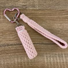 a pink crocheted keychain with a heart shaped hook attached to it