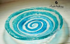 a blue and white bowl sitting on top of a wooden table