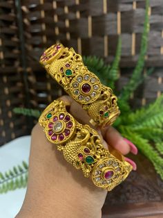 Temple bangle in matte gold and ruby stone. Detailing has the Rajasthani similarity. About an inch wide. Disclaimer: Price listed is for a single Kada. If you want to get them in a pair please select quantity 2. Ruby Stone, Matte Gold, Bracelet Watch, Temple, Ruby, Bangles, Charm Bracelet, Stone, Gold