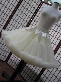 Pretty Pettiskirt Petty Coat, White Ruffled Dress For Dance, Vintage White Petticoat For Party, White Ruffle Dress For Dance, White Organza Petticoat With Ruffles, Fitted Organza Skirt With Attached Cancan, Elegant Tulle Petticoat With Ruffles, Wedding Stretch Petticoat With Tiered Skirt, Wedding Stretch Tiered Petticoat