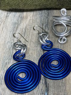 Earrings in Blue and Silver Round Circles inspired by the Zeta Phi Beta colors. Aluminum wire jewelry made by me with Love! I create fun handcrafted jewelry from anodized aluminum and sterling silver. Items are ready to ship, made to order and can be custom made to order. * Handmade Please note the picture is zoomed close to show the detail of the item *Items are handcrafted which means colors, sizes, shapes and designs may vary *Ready to ship items will be the item pictured *Made to order items Nickel-free Blue Metal Hoop Earrings, Nickel-free Spiral Blue Earrings, Unique Blue Hoop Earrings With Ear Wire, Blue Sterling Silver Hoop Earrings Nickel-free, Blue Sterling Silver Hoop Earrings Nickel Free, Unique Blue Spiral-shaped Jewelry, Cadmium-free Blue Earrings As Gift, Blue Spiral Sterling Silver Jewelry, Blue Dangle Earrings Cadmium-free