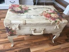 an old suitcase with flowers painted on it