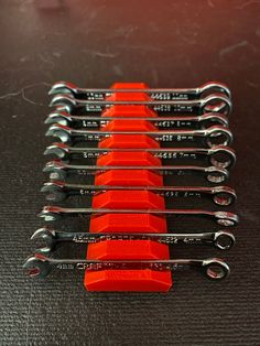 seven pairs of wrenches sitting on top of each other